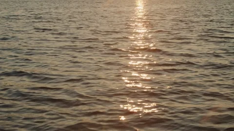 Reflection of the rays of the setting sun on the waves of the ocean, landscape Stock Footage 249293351