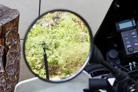 Reflection in the rearview mirror of a motorcycle Stock Photos