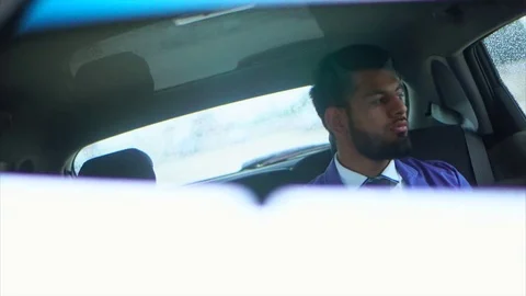 Reflection in the rearview mirror of the young muslim businessman Stock-Footage 77601020