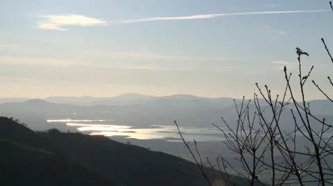 Reflection of a reservoir lake from the mountain, high clouds Stock Footage 49653672