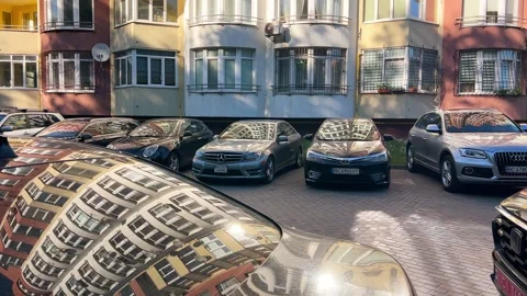 Reflection of a residential building visible on the polished car roofs and hoods Stock Footage 338240149