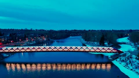 Reflection reveal moving even lower view of PeaceBridge Calgary Stock Footage 332368032