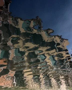Reflection with ripples of old building in canal for use as a background or.. Stock-Fotos