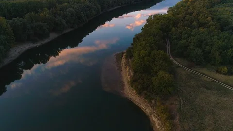 A reflection on a river of the sky and some trees, filmed with a drone from a 스톡 동영상 113427331