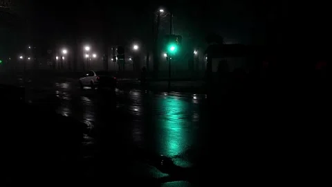 Reflection on the road from car headlights and traffic lights at night in fog Stock Footage 297850850