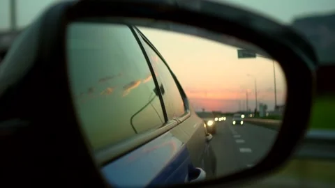 Reflection of the road in the rearview mirror Stock Footage 135923730