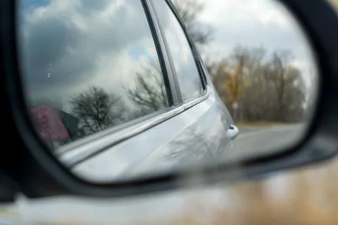 Reflection of the road in the rearview mirror Stock Photos