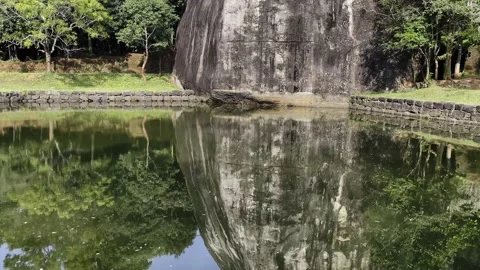 Reflection of a rock in the water, a pond under the sigiriya rock Stock Footage 219118789