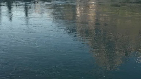 Reflection of a rocky mountain in flowing water. Mountain colored by golden Stock Footage 316152933