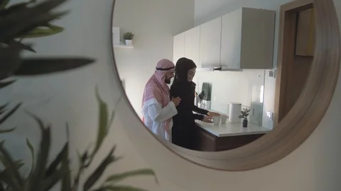 Reflection from a round Mirror a beautiful young Arab woman and her husband Stock Footage 113749440