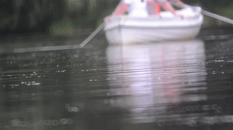 Reflection rowing boats seen the greenish water of a lake near forest Stock Footage 60781387