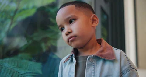 Reflection, sad and boy by window in home thinking of trauma, bad memory and Stock Footage 336697783