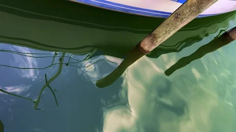 Reflection of a Sailing Boat on the Water Surface in a Sunny Summer Day Stock Footage 247047720