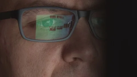 Reflection of scrolling sites in an eyeglasses of young adult man Stock Footage 72182626
