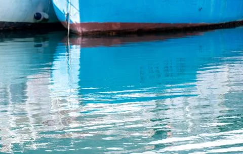 Reflection in the sea surface of white yachts parked in the port on the shore Stock Photos