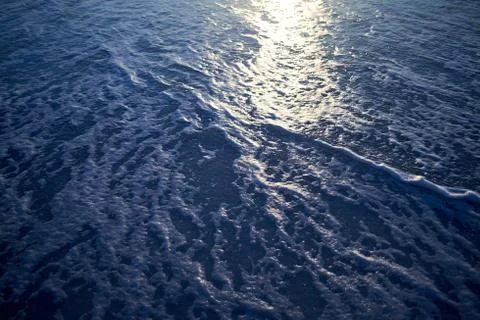 Reflection of the setting sun on the sea Stock Photos