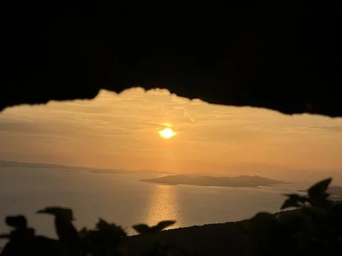 Reflection of the setting sun in sea water, view from the mountain. Sunset .. Stock Photos