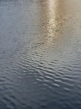 Reflection of the setting sun on the surface of the river. Stock Photos