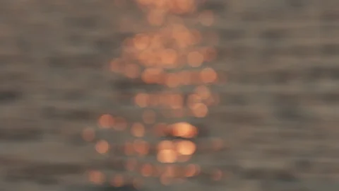 Reflection of the setting sun on the water in defocus. Stock Footage 128203118