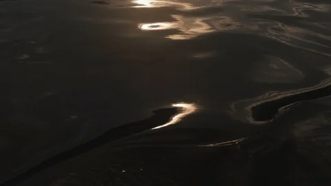 Reflection of the setting sun in water, sparkling Bokeh light Stock Footage 93357643