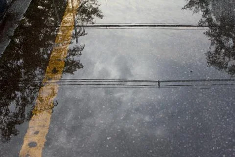Reflection shadow of electricity cable, sky and tree on the road Stock Photos