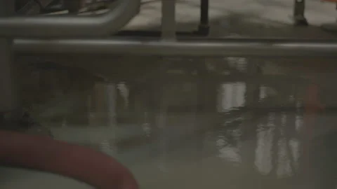 Reflection shimmering on layer of water on cement floor Video stock 202738160