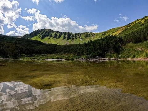 Reflection of Shpytsi Rock Formations in Mountain Lake Carpathian Mountains.. Stock Photos