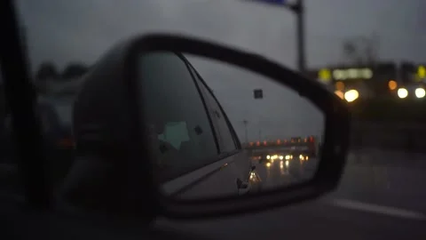 Reflection in the side mirror of a car while driving on a summer evening Stock Footage 144100390