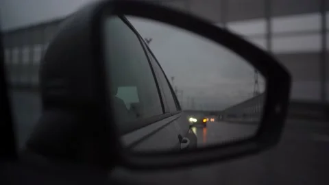 Reflection in the side mirror of a car while driving on a summer evening Stock Footage 144100399