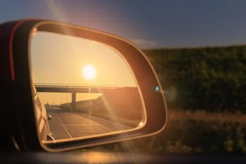 Reflection in the side view mirror. The car is driving in the evening. Stock Photos