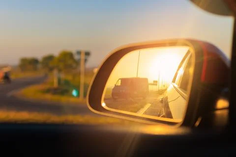 Reflection in the side view mirror. The car is driving in the evening. Stock Photos