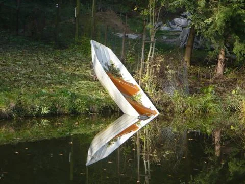 Reflection sinking rowboat on the water Stock Photos