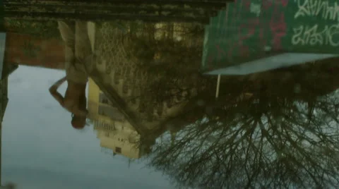 Reflection of skateboarder performing an ollie Stock Footage 61274961