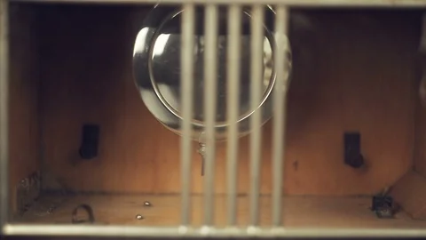 Reflection of the skull and candles in the pendulum of an old clock 库存影片 97864534