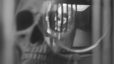 Reflection of the skull and candles in the pendulum of an old clock Stock Footage 100321665