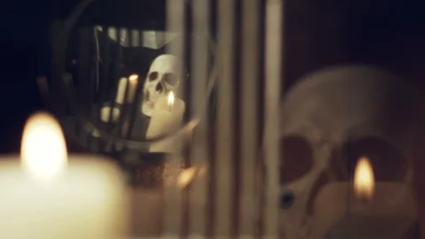 Reflection of the skull and candles in the pendulum of an old clock Stock Footage 100321783