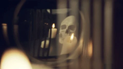 Reflection of the skull and candles in the pendulum of an old clock Stock Footage 100321848