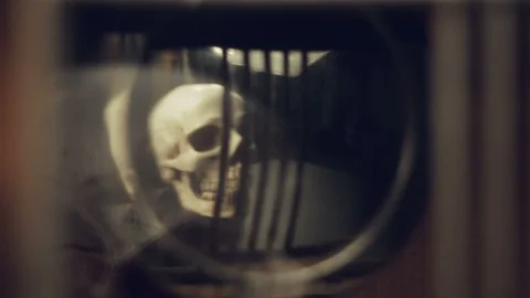 Reflection of the skull and candles in the pendulum of an old clock Stock Footage 108172017