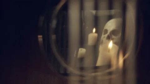 Reflection of the skull and candles in the pendulum of an old clock Stock Footage 108172675