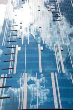 Reflection of the sky and clouds in building windows Stock Photos