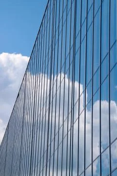 Reflection of the sky and clouds in Glass facade of a building Stock Photos