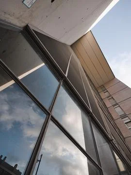 Reflection of sky and clouds in windows of a modern office building Stock Photos