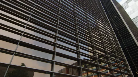 Reflection of the sky and modern building, on the windows of a skyscraper Stock Footage 220643359