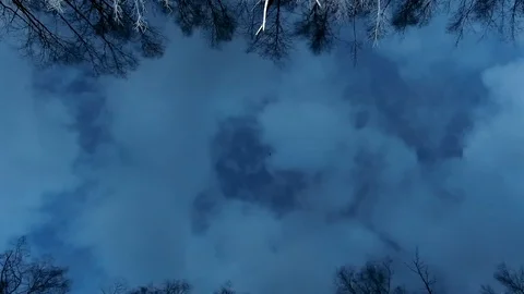 Reflection of sky clouds in the blue water of a forest lake at sunset Video stock 128232168