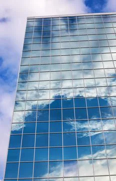 Reflection of sky with clouds in the glass building in downtown Stock Photos