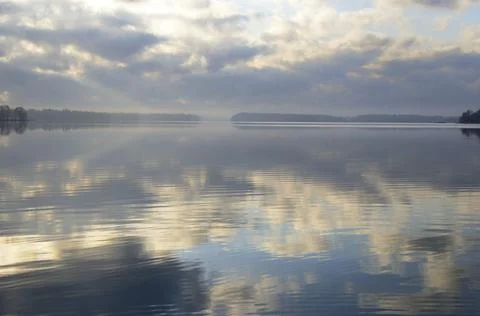 Reflection of the sky on the surface of the lake, Finland Stock Photos