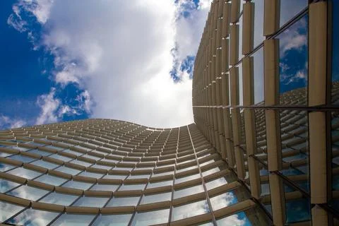 Reflection of the sky in the windows of an office building Stock Photos