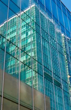 Reflection of skyscraper glass facade of a modern building Stock Photos