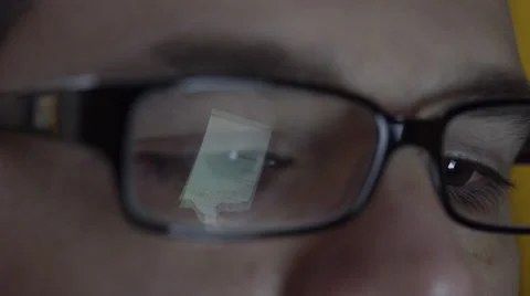 Reflection of smartphone on mans eyeglasses. 4K UHD. Stock Footage 49581254
