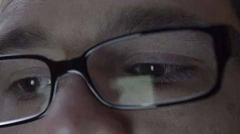 Reflection of smartphone on mans eyeglasses. 4K UHD. 動画素材 49584205